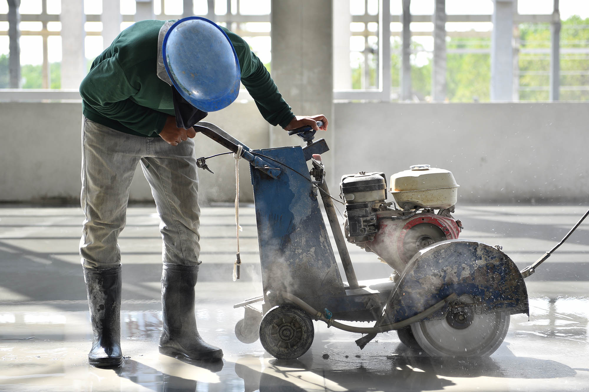 Worker,using,machine,cutting,concrete,for,expansion,and,isolation,joint