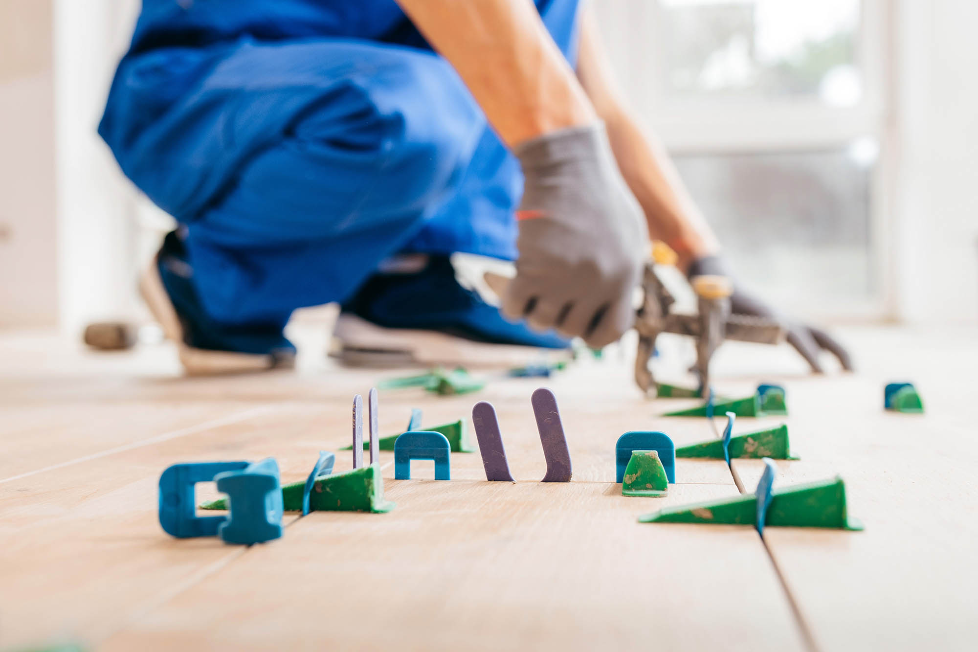 Close up hands of repairman in grey gloves and special uniform l